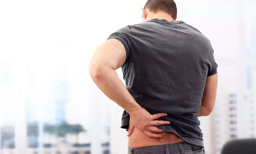 Man holding his lower back in pain