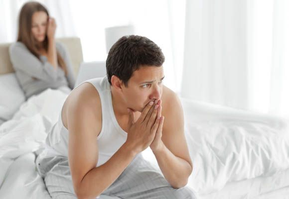 Sad man with a woman in the background